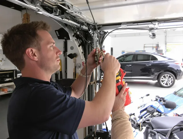 Paramount Garage Door Repair safety certified technician performing cable replacement in Paramount